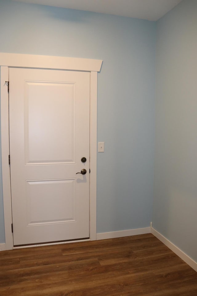 entryway with dark hardwood / wood-style flooring