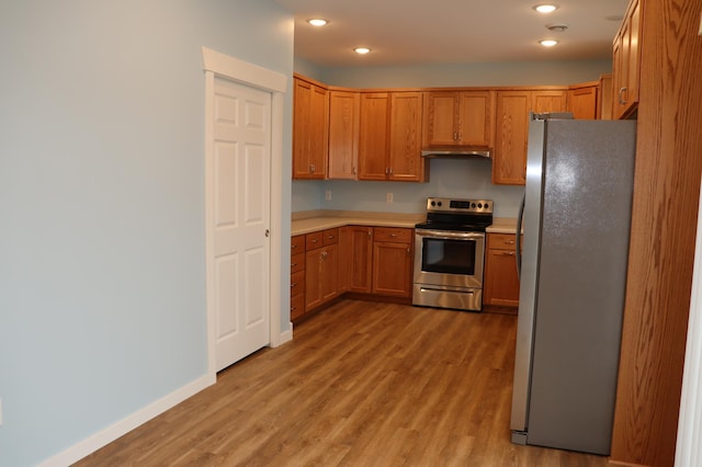 kitchen featuring appliances with stainless steel finishes and light hardwood / wood-style floors