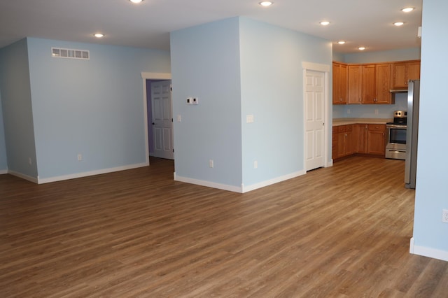 kitchen featuring dark wood-type flooring and stainless steel range with electric cooktop