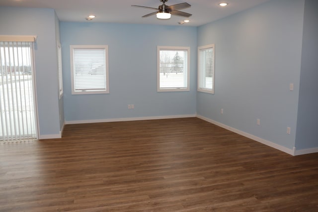 spare room featuring ceiling fan and dark hardwood / wood-style flooring