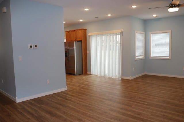 interior space featuring ceiling fan and dark hardwood / wood-style floors