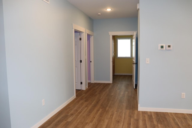 hallway with dark hardwood / wood-style floors