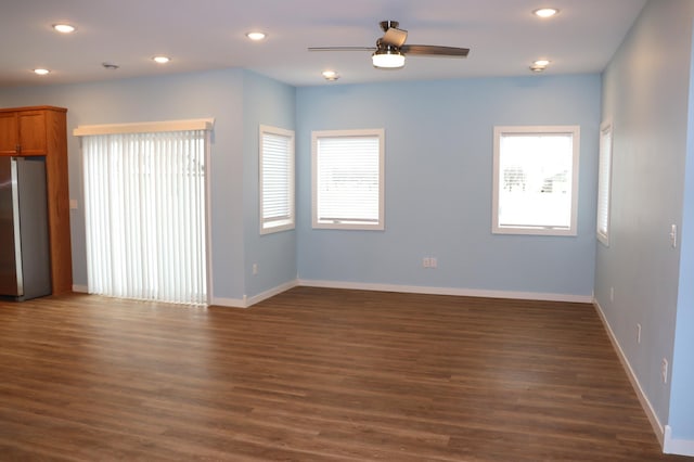 unfurnished room featuring ceiling fan and dark wood-type flooring