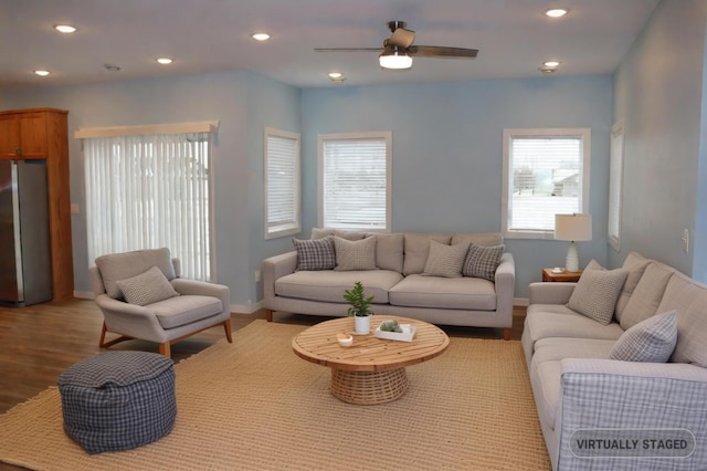 living room with ceiling fan and light hardwood / wood-style floors