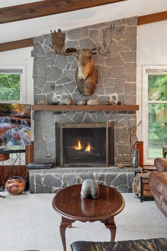 details with beam ceiling, a fireplace, and carpet