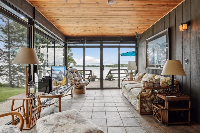 sunroom with a water view and wood ceiling