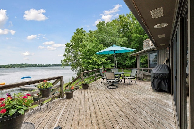 wooden terrace featuring a water view