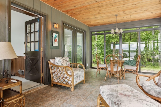 sunroom featuring wooden ceiling, french doors, and an inviting chandelier