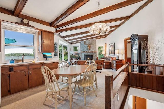 dining area featuring beamed ceiling, sink, light carpet, and a chandelier