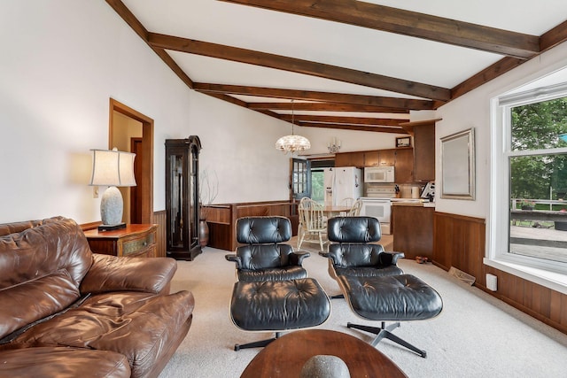 carpeted living room featuring lofted ceiling with beams, an inviting chandelier, a wealth of natural light, and wooden walls