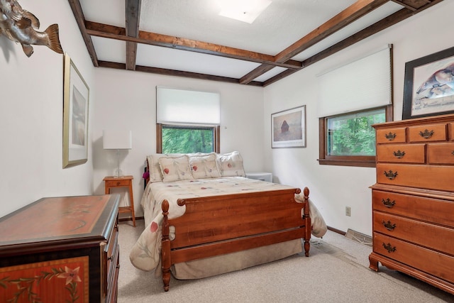 bedroom with multiple windows, light carpet, and beamed ceiling