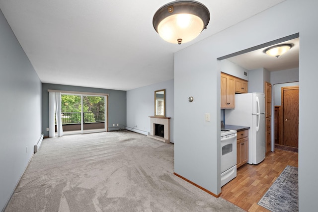 kitchen with a fireplace, white appliances, a baseboard radiator, and light hardwood / wood-style flooring