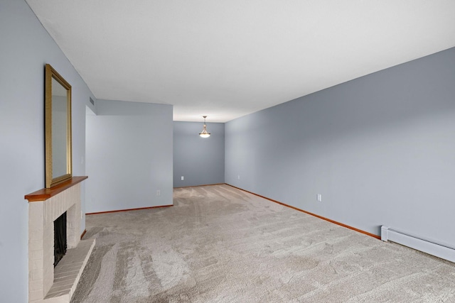 unfurnished living room featuring light carpet, a baseboard radiator, and a brick fireplace