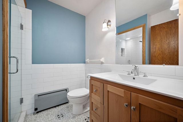 bathroom with vanity, tile patterned flooring, toilet, tile walls, and a shower with shower door