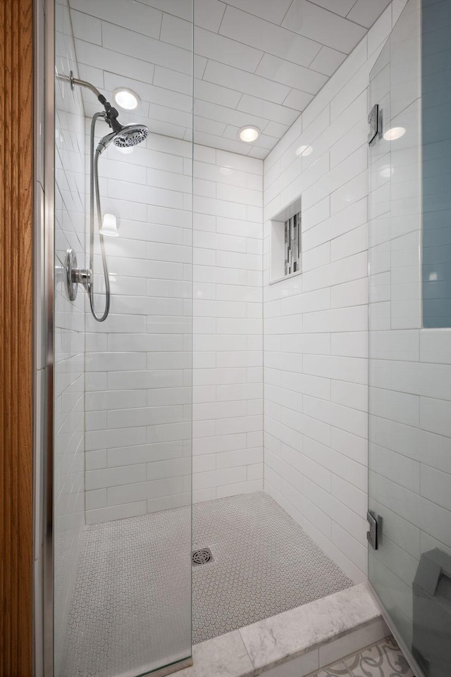 bathroom with a shower with door