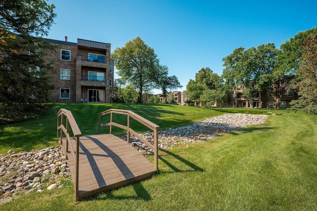 view of home's community featuring a lawn