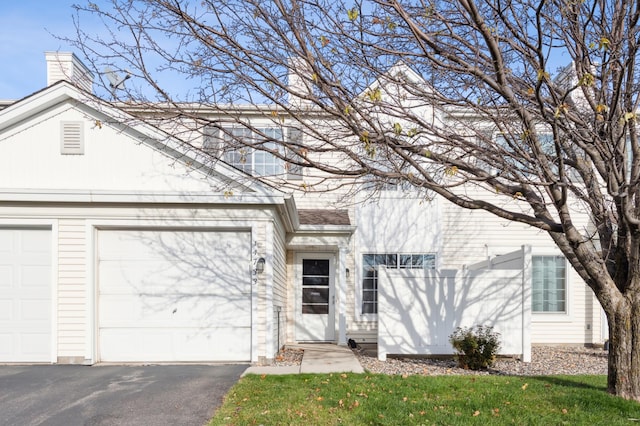 view of front of home with a front yard and a garage