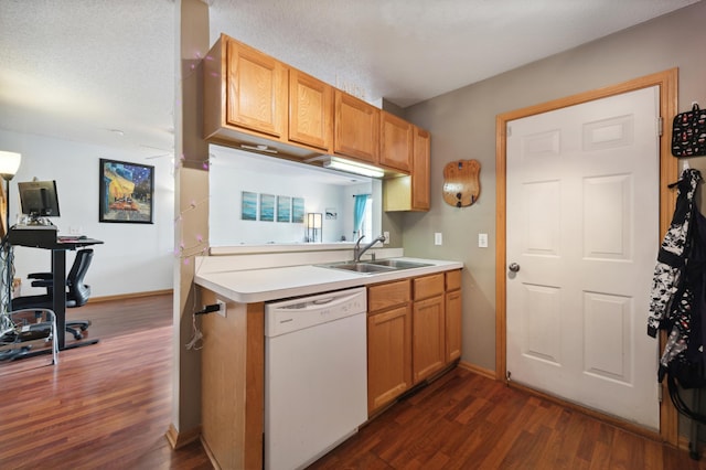 kitchen featuring dark wood-type flooring, white dishwasher, sink, a textured ceiling, and kitchen peninsula