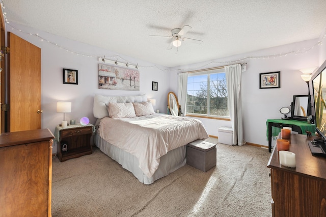 carpeted bedroom with a textured ceiling and ceiling fan