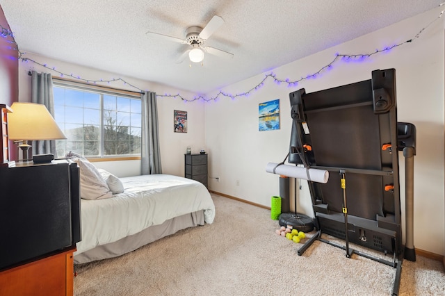 bedroom featuring light carpet, a textured ceiling, and ceiling fan