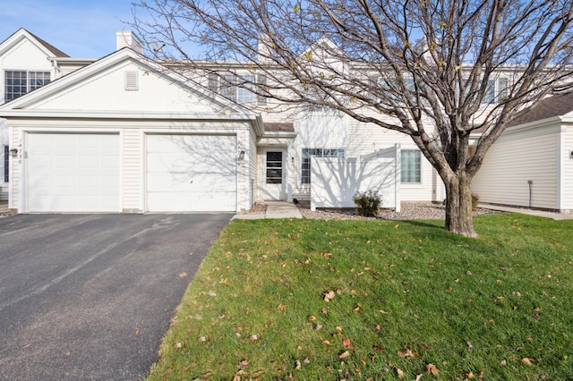 view of front of property with a front lawn and a garage