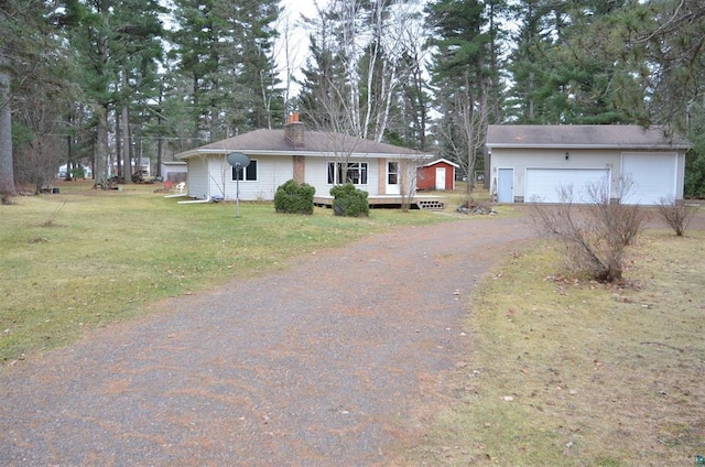 single story home with a wooden deck, a front lawn, and a garage