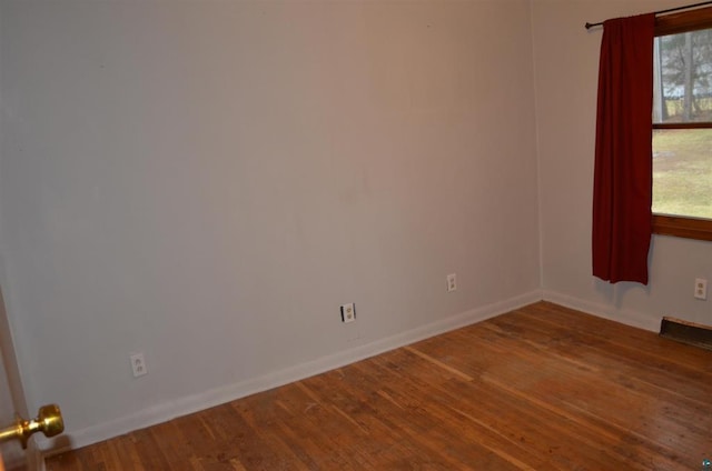 empty room with hardwood / wood-style flooring