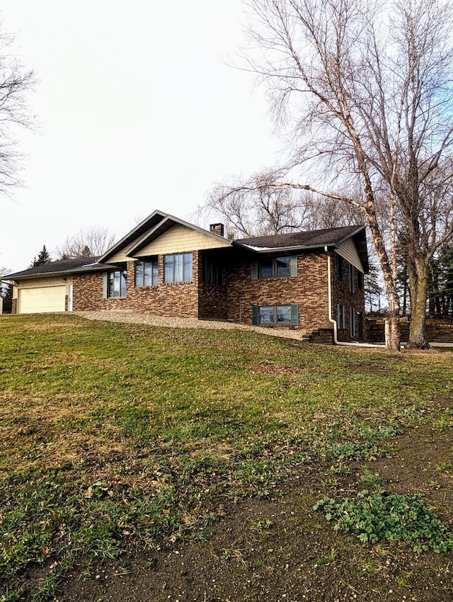 exterior space featuring a garage and a front lawn