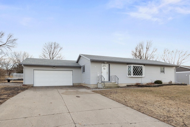 ranch-style house with concrete driveway and an attached garage