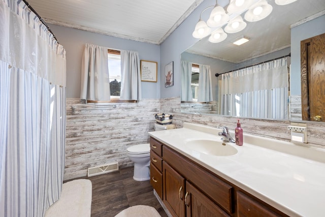 bathroom featuring visible vents, wainscoting, toilet, a shower with curtain, and vanity