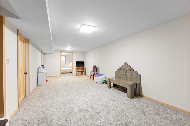 rec room with carpet floors and baseboards