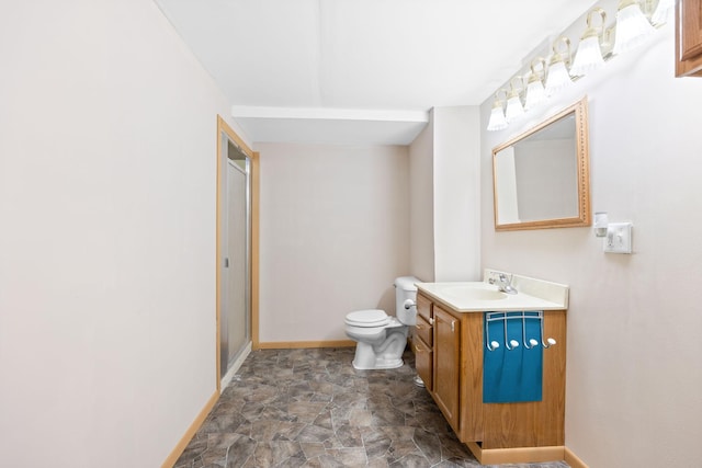 bathroom featuring stone finish floor, a shower stall, toilet, and baseboards