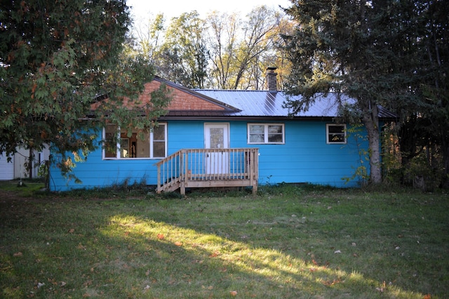 single story home with a front lawn and a wooden deck