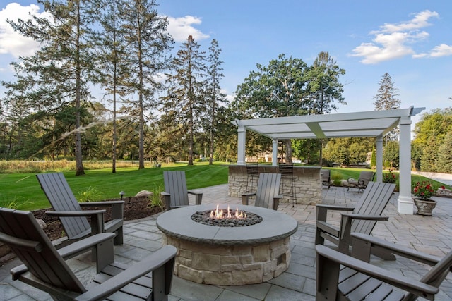 view of patio / terrace featuring an outdoor fire pit and a bar