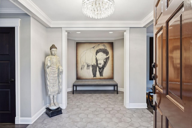 entrance foyer featuring ornamental molding and an inviting chandelier