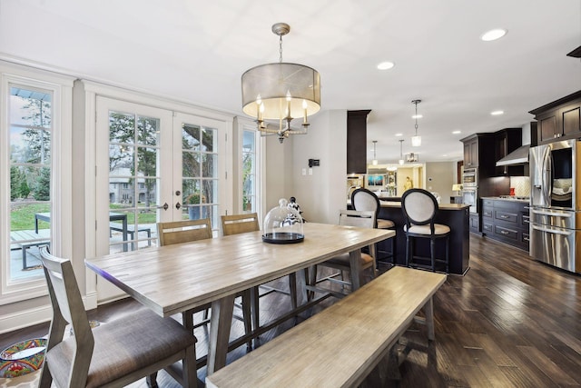 dining area featuring a notable chandelier, dark hardwood / wood-style floors, and french doors