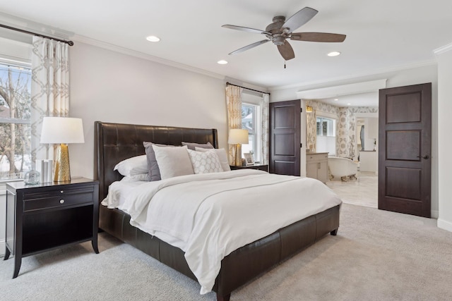 carpeted bedroom featuring ornamental molding, ensuite bathroom, and ceiling fan