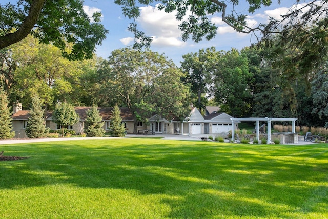 view of property's community with a pergola and a yard