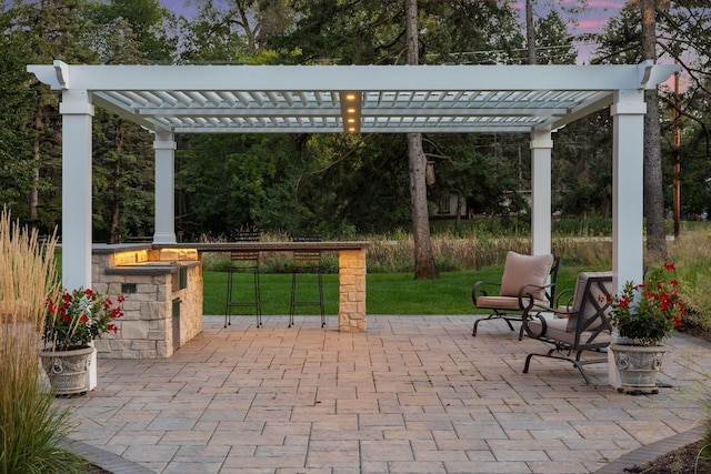 patio terrace at dusk with a pergola