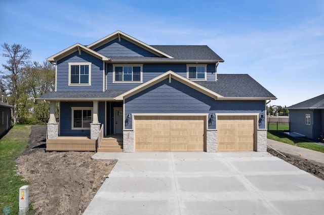 106 33rd Ave E, West Fargo, ND 58078 - craftsman-style house featuring a porch, concrete driveway, stone siding, and roof with shingles