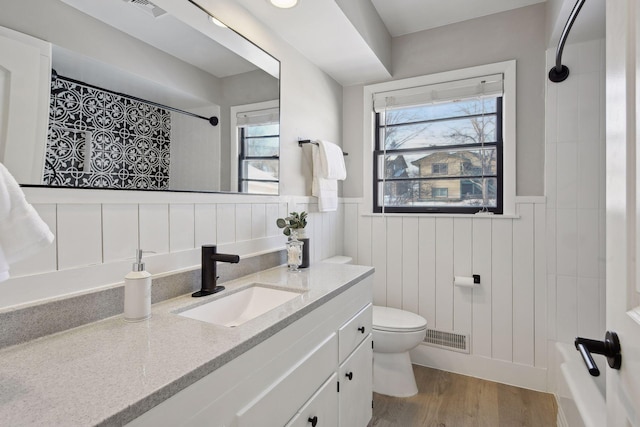 bathroom featuring vanity, hardwood / wood-style floors, and toilet