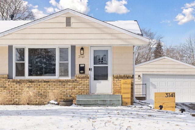 view of front facade featuring a garage and an outdoor structure