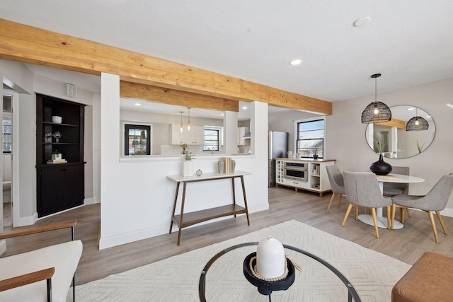 living room with beamed ceiling and wood-type flooring