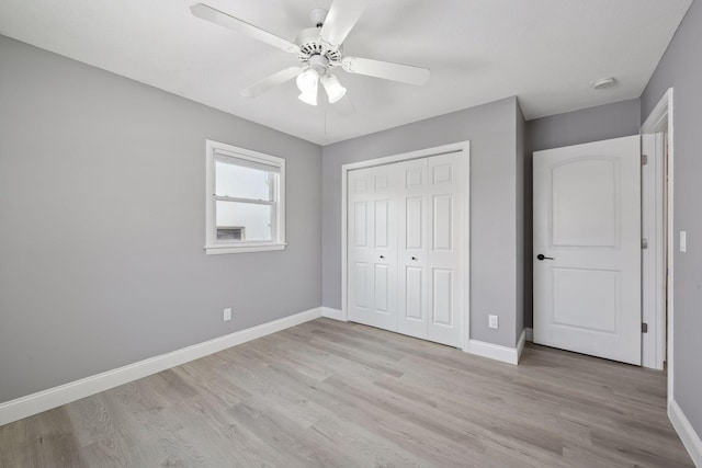 unfurnished bedroom featuring a closet, ceiling fan, and light wood-type flooring