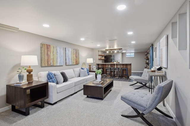 living room featuring light colored carpet and bar area