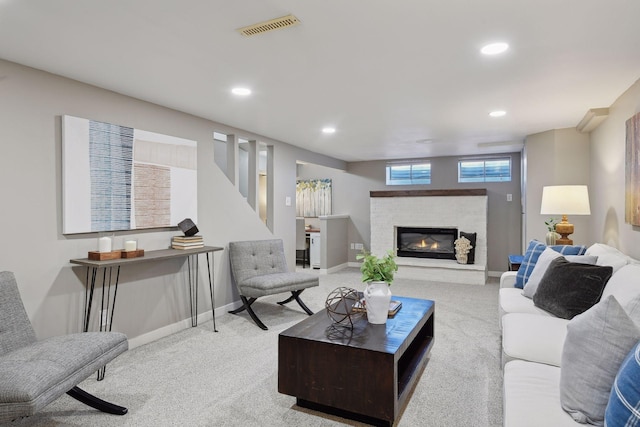 living room featuring a fireplace and light colored carpet