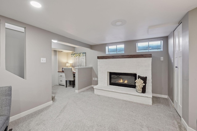 carpeted living room featuring a fireplace