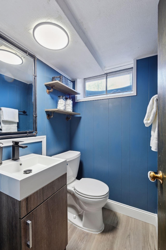 bathroom with vanity, hardwood / wood-style floors, a textured ceiling, and toilet