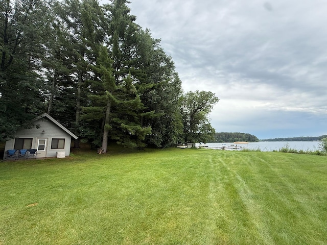 3929 County Road 17, Pequot Lakes, MN 56472 - view of green lawn featuring a water view and an outdoor structure