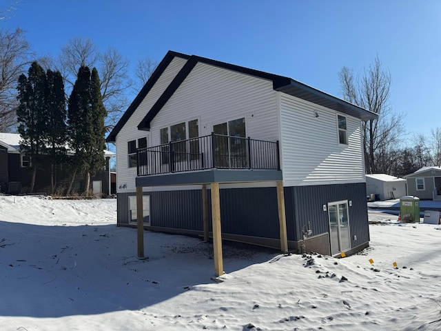 snow covered property featuring a balcony